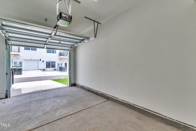 garage with central AC unit and a garage door opener