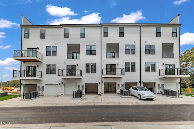 view of property with an attached garage and central AC