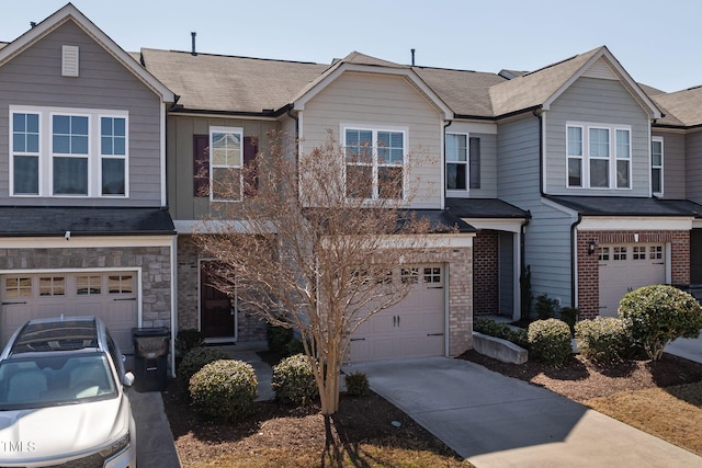 multi unit property featuring brick siding, a shingled roof, driveway, stone siding, and an attached garage