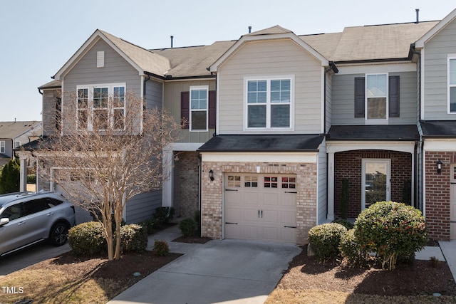 townhome / multi-family property featuring concrete driveway, brick siding, a garage, and roof with shingles