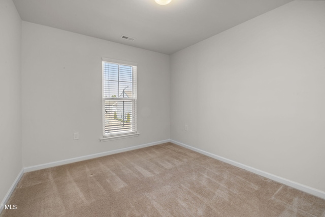 carpeted empty room with visible vents and baseboards