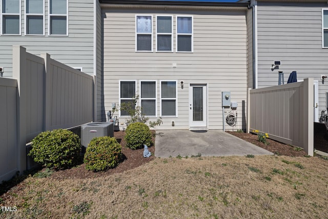 back of house with central air condition unit, a patio area, and fence