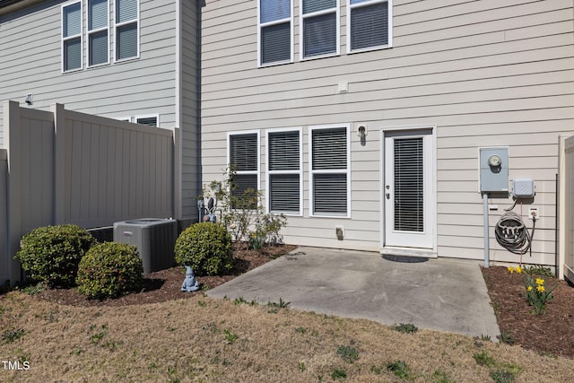 exterior space with a patio, central AC unit, and fence