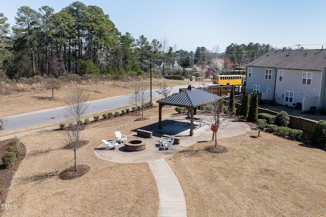 view of yard featuring a gazebo, a patio, fence, and an outdoor fire pit