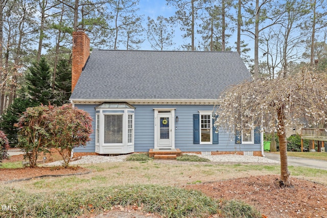 7112 Benhart Dr, Raleigh, NC 27613 - cape cod home with a chimney, a front lawn, and roof with shingles