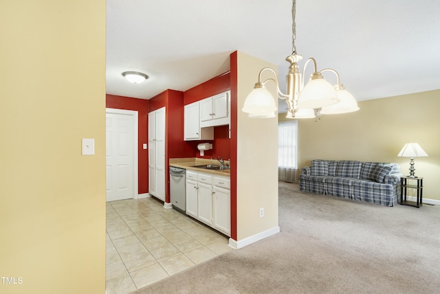 kitchen featuring stainless steel dishwasher, white cabinets, a notable chandelier, and light colored carpet