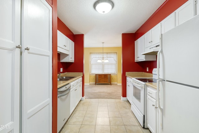 kitchen featuring under cabinet range hood, white appliances, white cabinets, and a sink