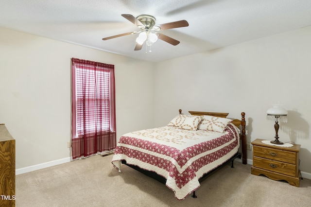 carpeted bedroom with baseboards, a textured ceiling, and ceiling fan