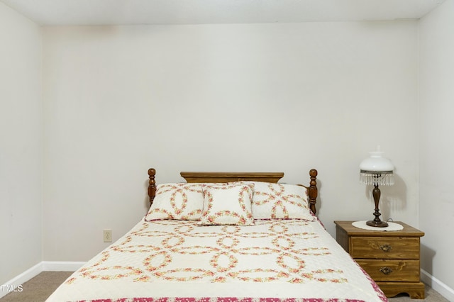 bedroom with carpet flooring and baseboards