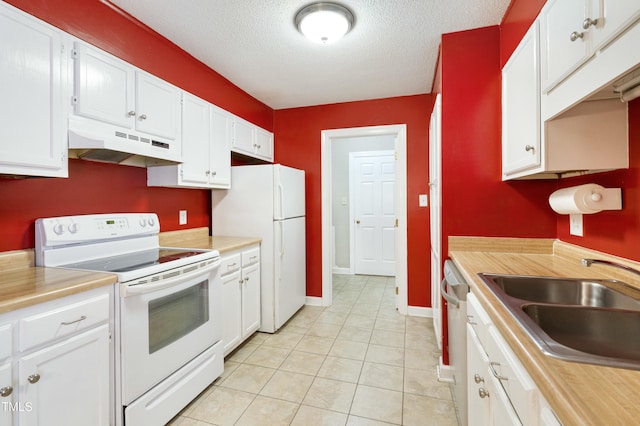 kitchen with under cabinet range hood, white appliances, light countertops, and a sink