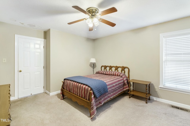 bedroom with ceiling fan, carpet, visible vents, and baseboards