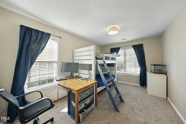 bedroom featuring visible vents, a textured ceiling, baseboards, and carpet