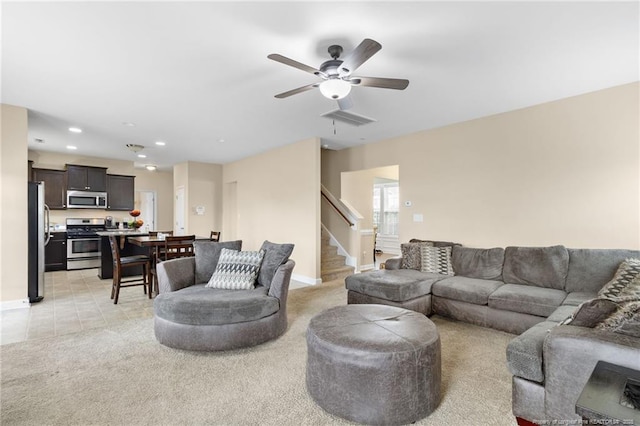 living room featuring visible vents, ceiling fan, stairway, light carpet, and recessed lighting