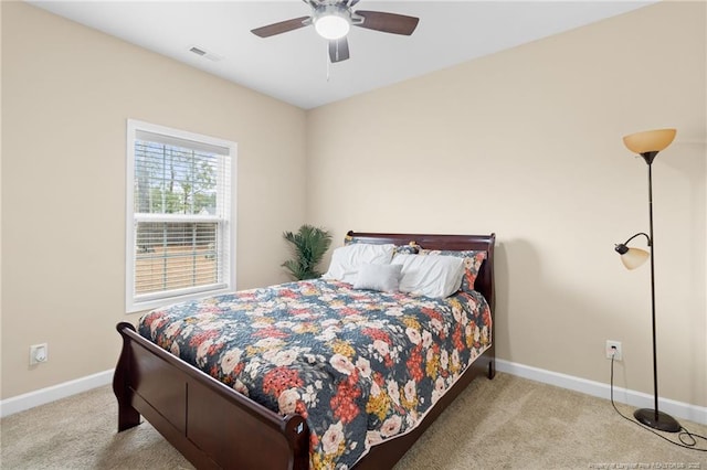 carpeted bedroom featuring visible vents, baseboards, and ceiling fan