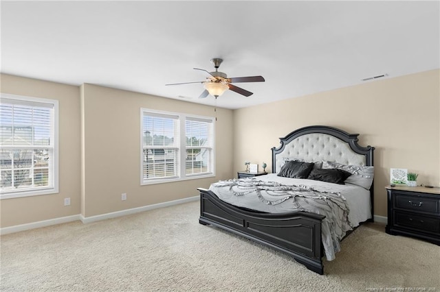 carpeted bedroom featuring visible vents, ceiling fan, and baseboards