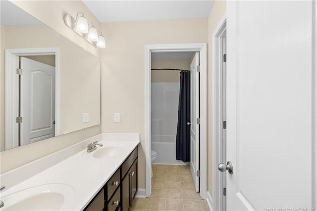 full bathroom featuring double vanity, toilet, shower / bath combo with shower curtain, and a sink