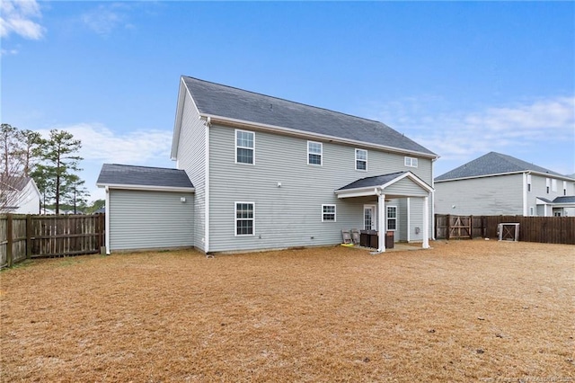 back of property with a fenced backyard