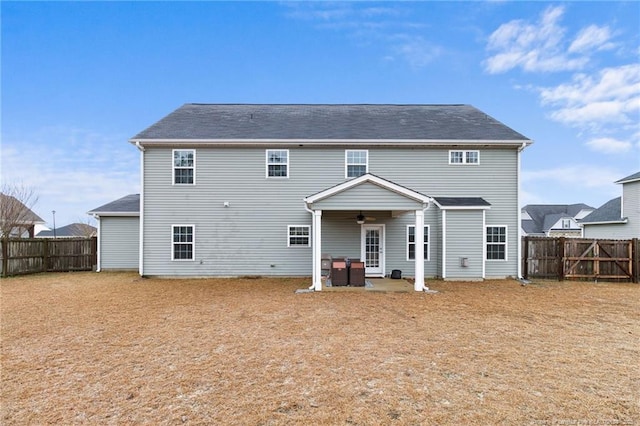 rear view of house featuring a fenced backyard, a patio area, and a ceiling fan