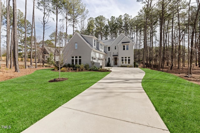 view of front of property with driveway and a front lawn