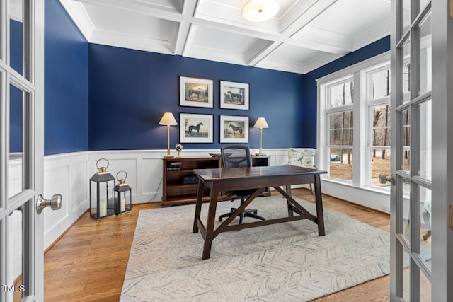 office featuring beamed ceiling, plenty of natural light, wood finished floors, and french doors