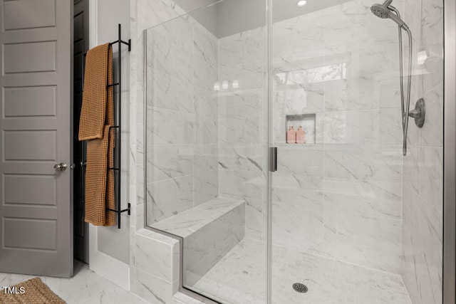 bathroom featuring a stall shower and marble finish floor