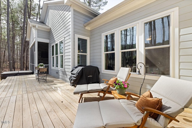 wooden deck with a grill and a covered hot tub