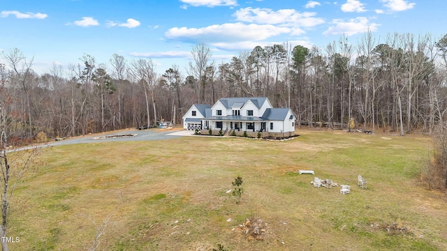 birds eye view of property with a wooded view