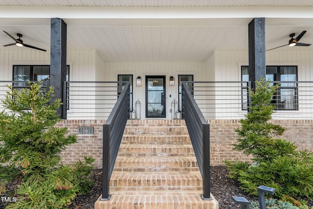 entrance to property with a porch, brick siding, and ceiling fan