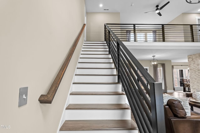 stairway featuring visible vents and a ceiling fan