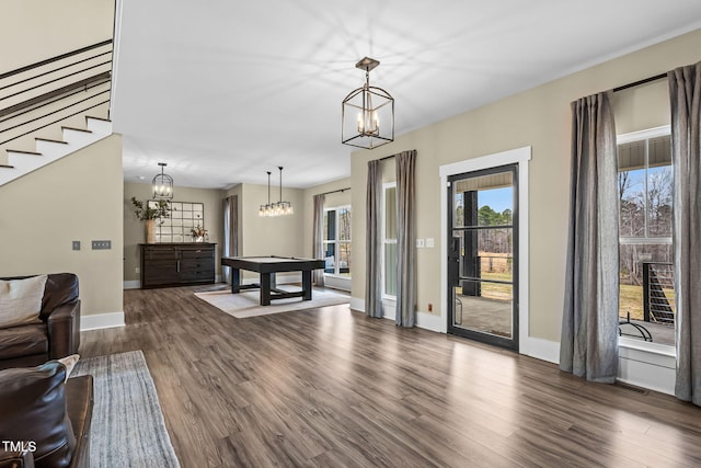 interior space with visible vents, baseboards, stairs, dark wood-style floors, and a notable chandelier