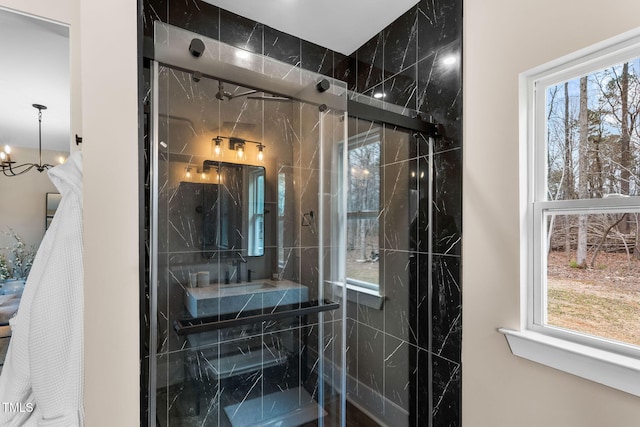 full bath featuring a marble finish shower