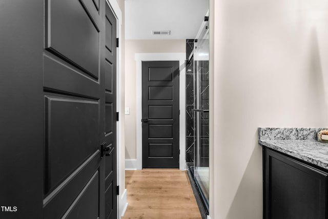 interior space featuring wood finished floors and visible vents