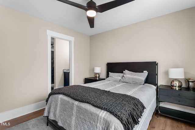 bedroom featuring ceiling fan, baseboards, and wood finished floors