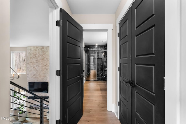 corridor featuring light wood-style floors