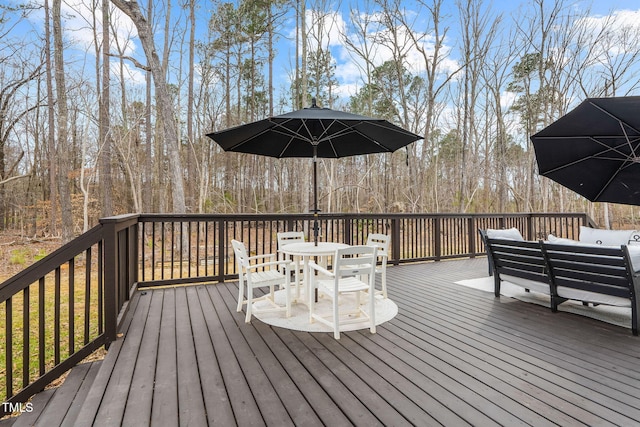 wooden terrace with an outdoor living space and outdoor dining area