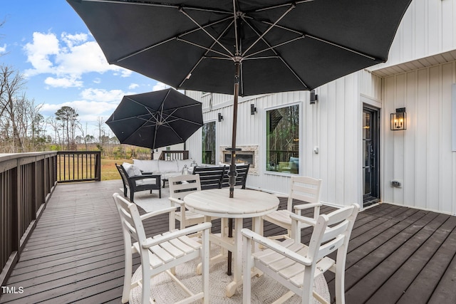 wooden terrace with outdoor dining area