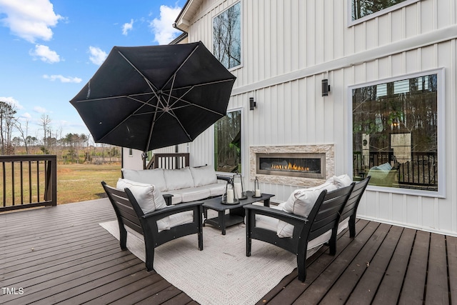 wooden deck featuring an outdoor living space with a fireplace