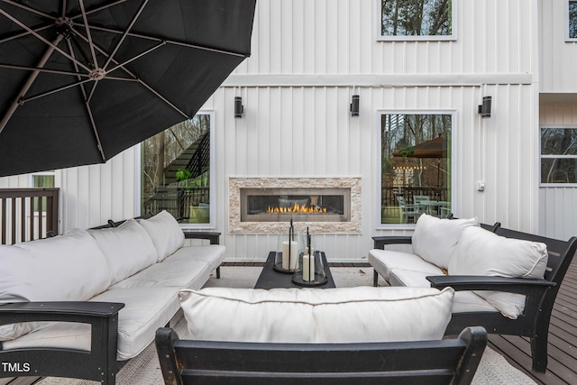 view of patio with an outdoor living space with a fireplace