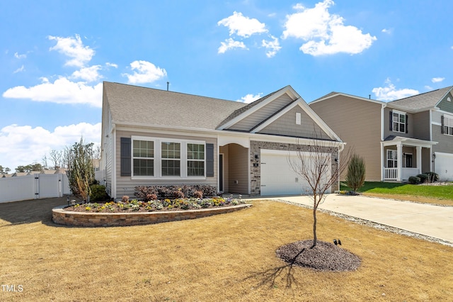 view of front of house featuring driveway, a front lawn, an attached garage, and a gate