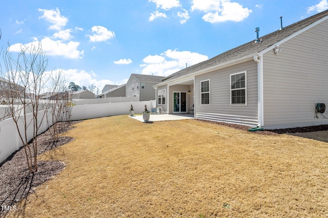 back of house with a patio area, a yard, and a fenced backyard