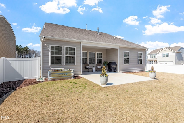 back of house with a patio, a yard, and a fenced backyard