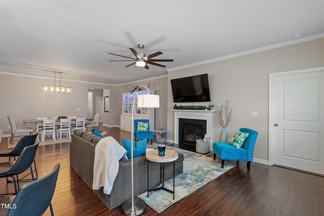 living room with a fireplace with flush hearth, ornamental molding, ceiling fan, and wood finished floors