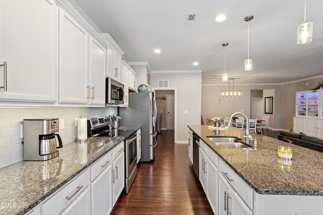 kitchen with visible vents, a sink, appliances with stainless steel finishes, white cabinets, and dark wood-style flooring