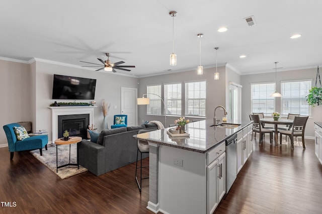 kitchen featuring visible vents, ceiling fan, dishwasher, white cabinetry, and a sink