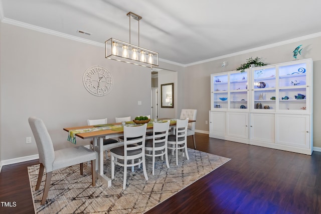 dining space with wood finished floors, baseboards, and ornamental molding