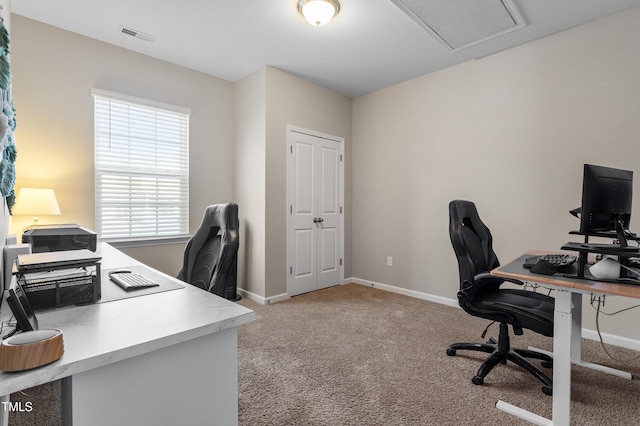 home office featuring light carpet, visible vents, attic access, and baseboards