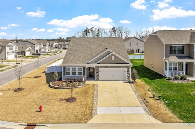 traditional-style house with a residential view, an attached garage, driveway, and a front yard