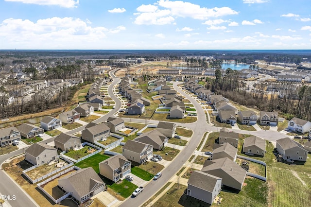 drone / aerial view with a residential view and a water view