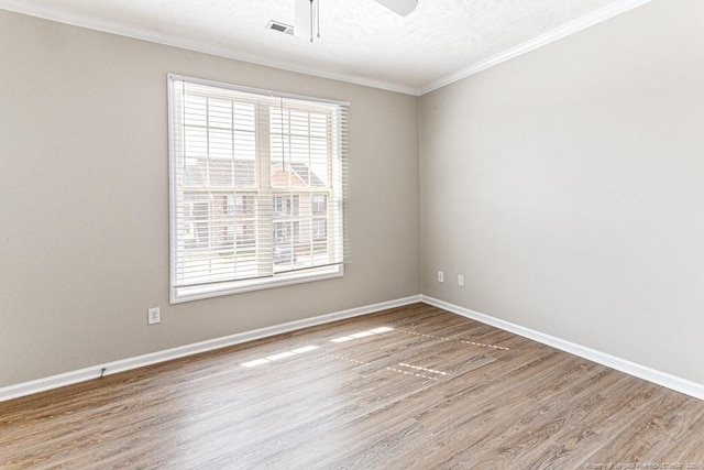 unfurnished room with visible vents, baseboards, wood finished floors, a textured ceiling, and a ceiling fan