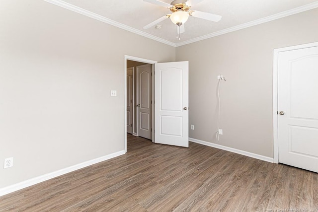 unfurnished bedroom featuring ceiling fan, wood finished floors, baseboards, and ornamental molding